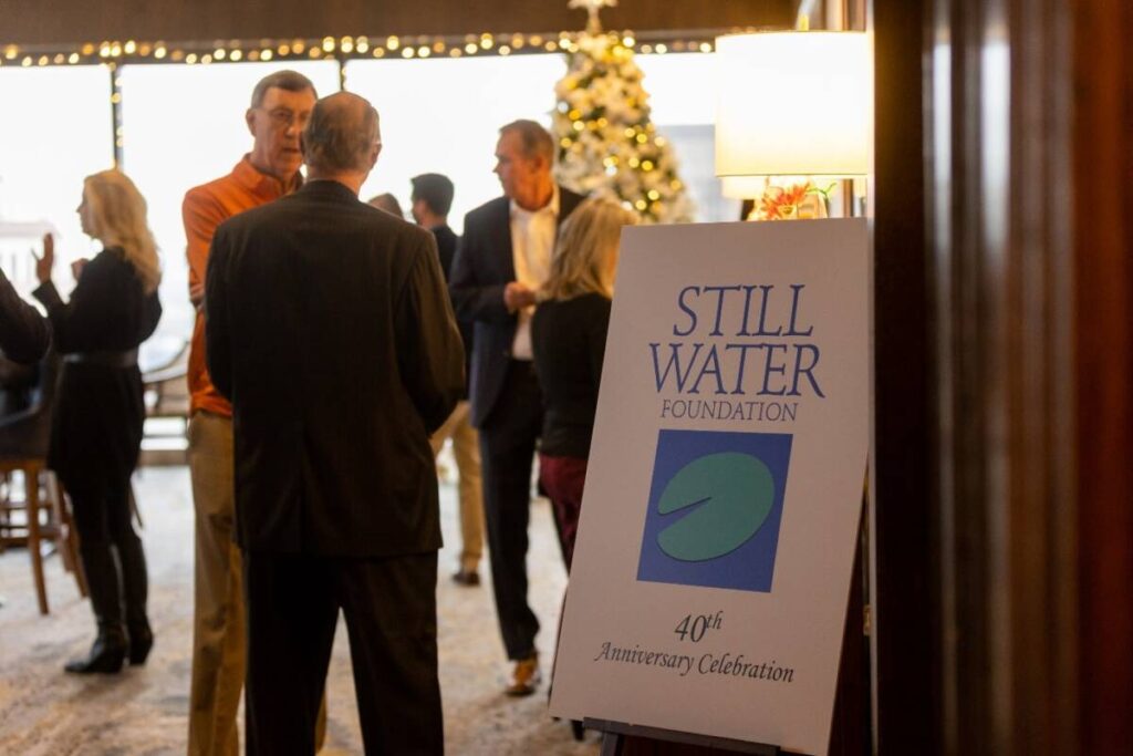 Entrance to Still Water Foundation's 40th Anniversary Celebration with guests in background.